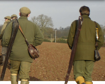 Image of the guns walking to the first drive at Willey Park shoot over a ploughed field